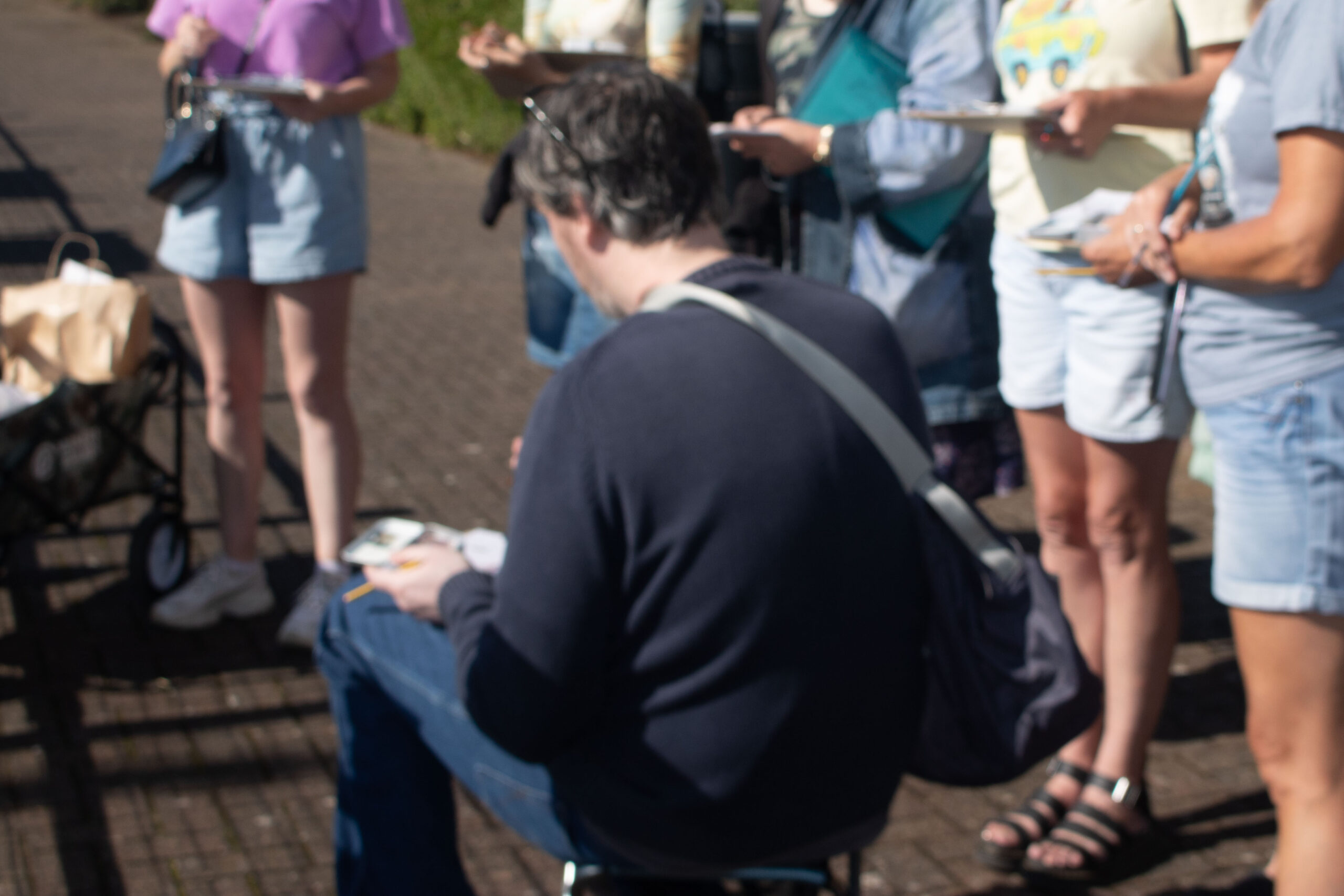 Joseph showing a group how to sketch